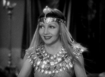 Movie still from “Cleopatra” (1934), directed by Cecil B. DeMille – A woman wearing a necklace and a dress; Close Up shot, High angle