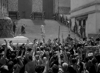 Movie still from “Cleopatra” (1934), directed by Cecil B. DeMille – A crowd of people standing on steps in front of a building; Extreme Wide shot, High angle