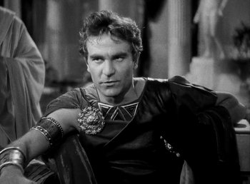 Movie still from “Cleopatra” (1934), directed by Cecil B. DeMille – Black and white photograph of a man in a roman outfit; Close Up shot, Low angle