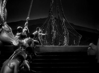 Movie still from “Cleopatra” (1934), directed by Cecil B. DeMille – A black and white photo of a group of people climbing stairs; Extreme Wide shot, High angle
