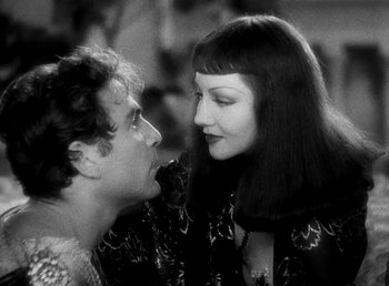 Movie still from “Cleopatra” (1934), directed by Cecil B. DeMille – A man and a woman looking at one another; Close Up shot, Over the shoulder angle
