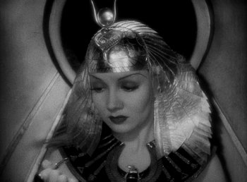 Movie still from “Cleopatra” (1934), directed by Cecil B. DeMille – A woman in a black and white photo wearing a headpiece; Close Up shot, High angle