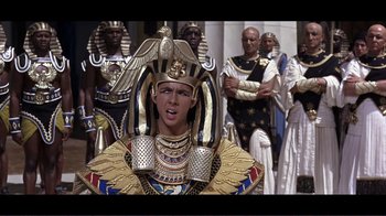 Movie still from “Cleopatra” (1963), directed by Rouben Mamoulian – A group of people dressed in ancient egyptian costumes; Medium shot, High angle