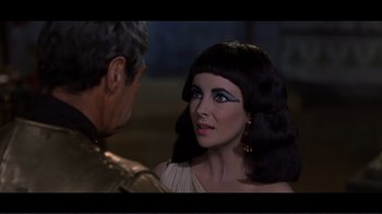 Movie still from “Cleopatra” (1963), directed by Rouben Mamoulian – A man and a woman are looking at each other; Close Up shot, Over the shoulder angle