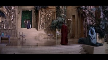 Movie still from “Cleopatra” (1963), directed by Rouben Mamoulian – A man in a red robe standing in front of a staircase; Extreme Wide shot, High angle