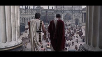Movie still from “Cleopatra” (1963), directed by Rouben Mamoulian – Two men in roman garb looking out over a crowd of people; Extreme Wide shot, High angle