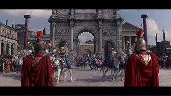 Movie still from “Cleopatra” (1963), directed by Rouben Mamoulian – A group of people riding horses in front of an archway; Extreme Wide shot, Low angle