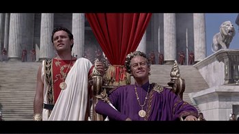 Movie still from “Cleopatra” (1963), directed by Rouben Mamoulian – Two men dressed in ancient roman garb and one is wearing a crown and one is wearing a purple robe; Medium shot, Low angle