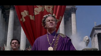 Movie still from “Cleopatra” (1963), directed by Rouben Mamoulian – A man wearing a crown and a purple robe; Medium shot, Low angle