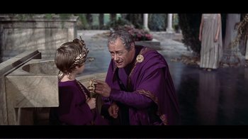 Movie still from “Cleopatra” (1963), directed by Rouben Mamoulian – An older man and a young girl dressed in medieval garb; Medium shot, High angle