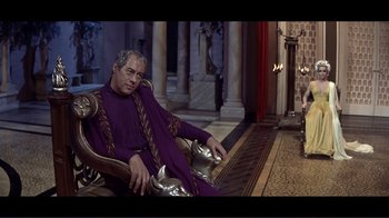 Movie still from “Cleopatra” (1963), directed by Rouben Mamoulian – An older man sitting in a chair wearing a purple robe; Medium shot, High angle