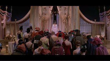 Movie still from “Cleopatra” (1963), directed by Rouben Mamoulian – A group of people sitting in front of an altar; Extreme Wide shot, High angle