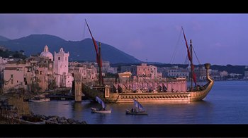 Movie still from “Cleopatra” (1963), directed by Rouben Mamoulian – Two boats in a body of water near a city; Extreme Wide shot, Low angle