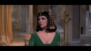 Movie still from “Cleopatra” (1963), directed by Rouben Mamoulian – A person wearing a green dress; Close Up shot, Over the shoulder angle