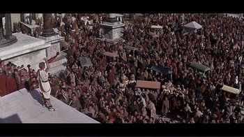 Movie still from “Cleopatra” (1963), directed by Rouben Mamoulian – A large crowd of people gathered together in the street; Extreme Wide shot, High angle