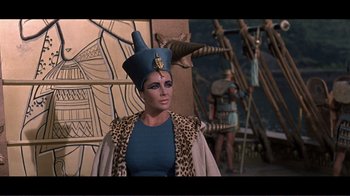Movie still from “Cleopatra” (1963), directed by Rouben Mamoulian – A person wearing a hat; Medium shot, Over the shoulder angle