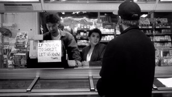Movie still from “Clerks” (1994), directed by Kevin Smith – A man and a woman at a store counter; Medium shot, Over the shoulder angle