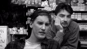 Movie still from “Clerks” (1994), directed by Kevin Smith – Two men are standing in front of a store; Close Up shot, Low angle