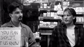 Movie still from “Clerks” (1994), directed by Kevin Smith – Two men standing next to each other in a store; Close Up shot, Over the shoulder angle