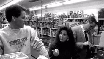 Movie still from “Clerks” (1994), directed by Kevin Smith – A black - and - white photo of people in a grocery store; Medium shot, Over the shoulder angle