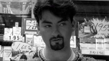 Movie still from “Clerks” (1994), directed by Kevin Smith – Black and white photograph of a man with a beard; Close Up shot, Overhead angle