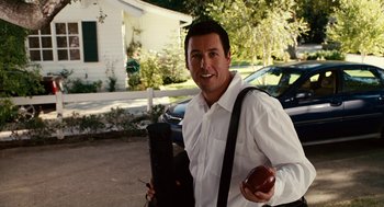 Movie still from “Click” (2006), directed by Frank Coraci – A man in a white dress shirt holding an apple; Medium shot, Over the shoulder angle