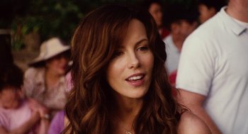 Movie still from “Click” (2006), directed by Frank Coraci – A person with long brown hair; Close Up shot, Over the shoulder angle