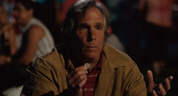 Movie still from “Click” (2006), directed by Frank Coraci – A person holding a piece of food; Close Up shot, Over the shoulder angle