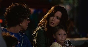 Movie still from “Click” (2006), directed by Frank Coraci – A woman and two young girls standing next to each other; Close Up shot, Over the shoulder angle