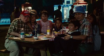 Movie still from “Click” (2006), directed by Frank Coraci – A group of people sitting at a picnic table; Medium shot, High angle
