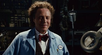 Movie still from “Click” (2006), directed by Frank Coraci – A man in a blue lab coat and a red bow tie; Medium shot, Low angle