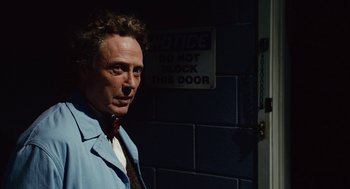 Movie still from “Click” (2006), directed by Frank Coraci – A man standing in front of a brick wall; Close Up shot, Low angle