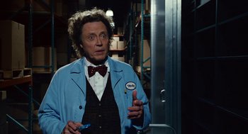 Movie still from “Click” (2006), directed by Frank Coraci – A man in a blue jacket and a red bow tie; Medium shot, Over the shoulder angle