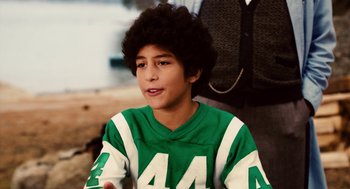Movie still from “Click” (2006), directed by Frank Coraci – A young man in a green and white football jersey; Close Up shot, High angle