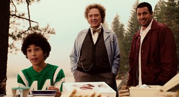 Movie still from “Click” (2006), directed by Frank Coraci – A man standing next to a table with a cake on it; Medium shot, Over the shoulder angle