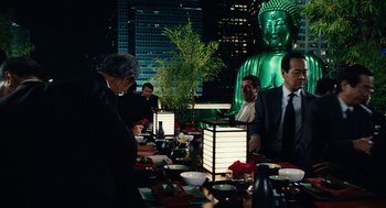 Movie still from “Click” (2006), directed by Frank Coraci – A group of people sitting at a table with food; Medium shot, Over the shoulder angle