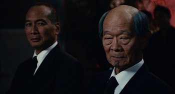 Movie still from “Click” (2006), directed by Frank Coraci – Two men in suits and ties are standing next to each other; Close Up shot, Over the shoulder angle