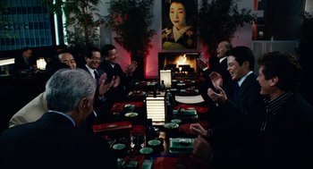 Movie still from “Click” (2006), directed by Frank Coraci – A group of people sitting at a table with food; Medium shot, Over the shoulder angle