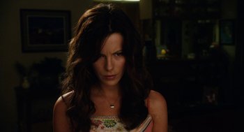 Movie still from “Click” (2006), directed by Frank Coraci – A beautiful woman with long dark brown hair; Close Up shot, Over the shoulder angle