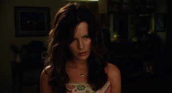 Movie still from “Click” (2006), directed by Frank Coraci – A beautiful woman with long dark brown hair; Close Up shot, Over the shoulder angle