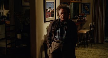 Movie still from “Click” (2006), directed by Frank Coraci – An older man standing in front of a picture; Medium shot, Over the shoulder angle