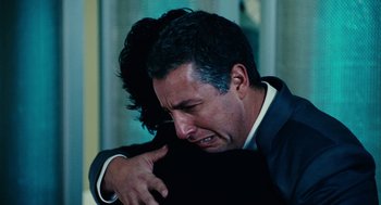 Movie still from “Click” (2006), directed by Frank Coraci – A man hugging another man who is holding his head down; Close Up shot, Over the shoulder angle