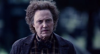 Movie still from “Click” (2006), directed by Frank Coraci – An older man in a bow tie and a plaid jacket; Close Up shot, Over the shoulder angle