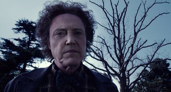 Movie still from “Click” (2006), directed by Frank Coraci – An old man with a curly hair wearing a plaid shirt; Close Up shot, Low angle