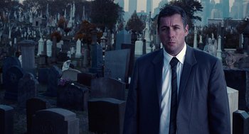 Movie still from “Click” (2006), directed by Frank Coraci – A man wearing a suit and tie standing in a cemetery; Medium shot, Over the shoulder angle