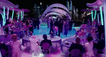 Movie still from “Click” (2006), directed by Frank Coraci – A group of people standing around tables in a room; Wide shot, High angle