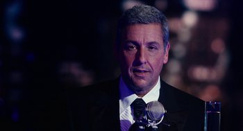 Movie still from “Click” (2006), directed by Frank Coraci – A person wearing a suit and tie; Close Up shot, Low angle