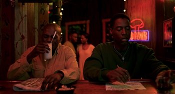 Movie still from “Clockers” (1995), directed by Spike Lee – A couple of men sitting at a table in a room; Medium shot, Over the shoulder angle