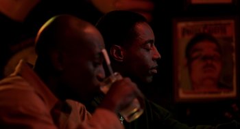 Movie still from “Clockers” (1995), directed by Spike Lee – Two men sitting in front of each other drinking beer; Close Up shot, Low angle