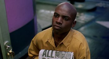 Movie still from “Clockers” (1995), directed by Spike Lee – A man holding a newspaper in front of his face; Close Up shot, High angle